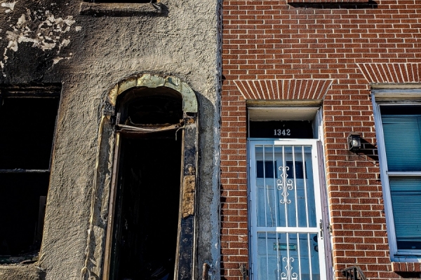 Two doorways side-by-side, one abandoned, one in use