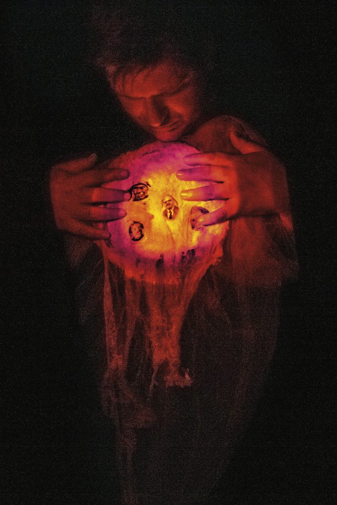Man holding filmy glowing orb
