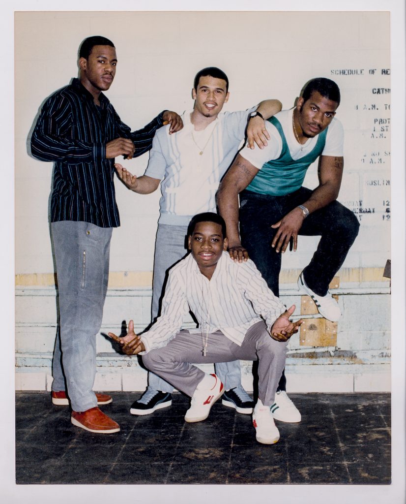Four young men pose for the camera in stylish clothes
