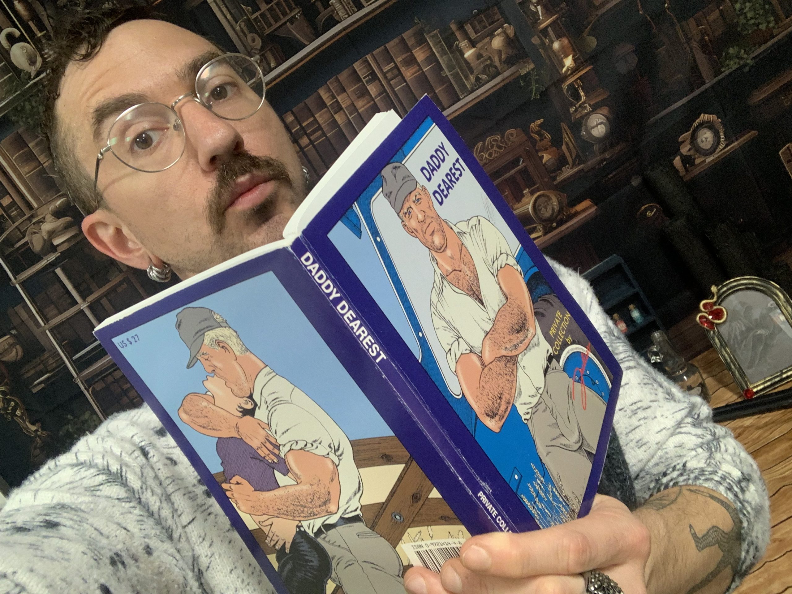 Man wearing glasses reading book
